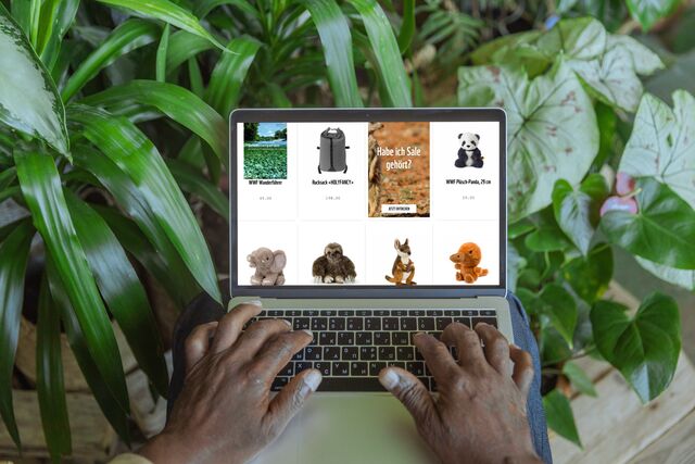 WWF Shop Products on computer with plants in the background