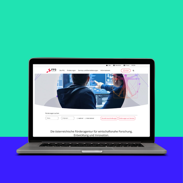 Laptop mit offener Webseite, die Informationen über wirtschaftliche Forschung und Innovation zeigt. Hintergrund in leuchtenden Farben.
