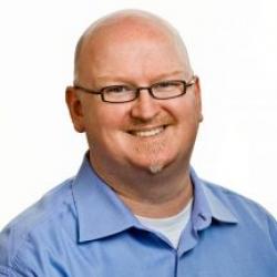 Bold Man with Glasses and Blue shirt
