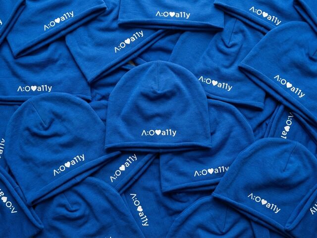 Blue beanies scattered, each with "a:o love a11y" in white text and a heart icon.